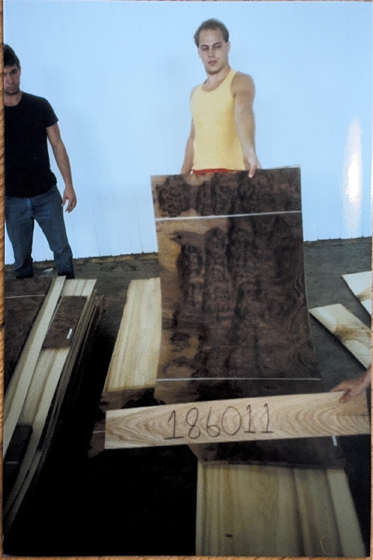 Supplier holding a bundle of figured veneer, circa 1980s